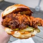 Nashville Hot Chicken Sandwich - Buttermilk fried chicken thigh dredged in a seasoned oil with dill pickles on a toasted bun