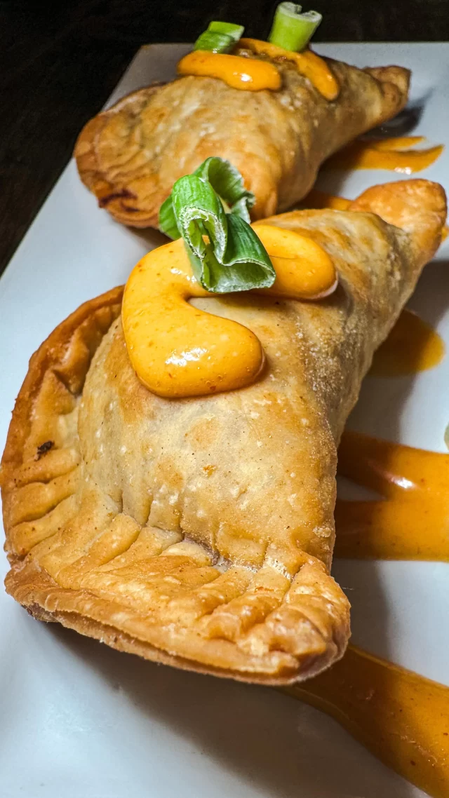 Craving something crispy and packed with flavor? Try our Pulled Chicken Empanadas during Happy Hour! These golden-fried delights are stuffed with tender pulled chicken and melty cheddar cheese, then served with a zesty sriracha aioli for dipping. Available Tuesday to Saturday from 3 PM to 6 PM and all day Sunday, these empanadas have been such a hit we’re thinking of adding them to our main menu. Come in, give them a taste, and let us know if they should make the big move!